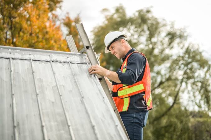 Roofing consultant inspecting a residential roof with a homeowner
