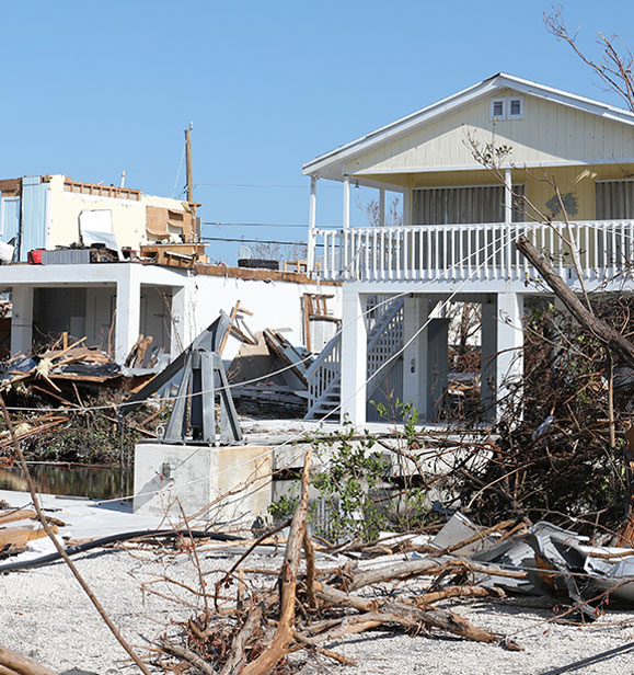 Roofing crew repairing storm-damaged roofing on a Southwest Florida home